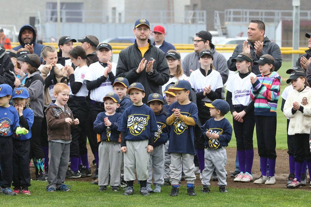 The Bees and others applaud the opening day ceremonies. (Photo by John Fisken)