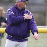 Coach Cody Anderson passes along a signal to an Oak Harbor baserunner. (Photo by John Fisken)
