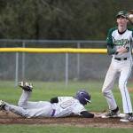 Noah Meffert slides safely back into first on a pickoff attempt as Marysville-Getchells Colten Bayley receives the throw.(Photo by John Fisken)