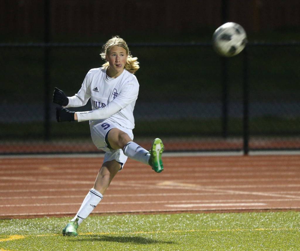 Mason Rhodes takes a corner kick for Oak Harbor.(Photo by John Fisken)