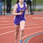 Alex Smith pulls away from the field in the last lap on the way to winning the 3,200. (Photo by John Fisken)