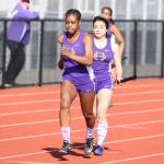 Kia Ceya, left, receives the baton from Alora Caillier in the 4x100 relay.(Photo by John Fisken)