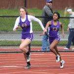 Leielle Salinger, left, and Jessica Vester pass the baton in the 4x200 relay.(Photo by John Fisken)