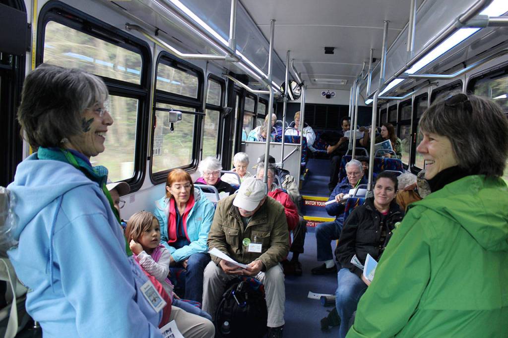Island Transit tour guide Maribeth Crandell (right) chats with volunteer Bonnie Gretz (left) of the Langley Whale Center during Saturdays ride to the towns whale parade and festival. Almost two dozen people signed up for the round-trip tour. Passengers continue to be picked up at usual stops during the tours.