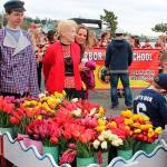 During the 2017 Holland Happening parade, Sande Mulkey (in red jacket) accompanies Jacob Hutson, left, and the traditional Dutch tulip cart. Mulkey is this years Grand Marshal for Saturdays parade that begins at 11 a.m.