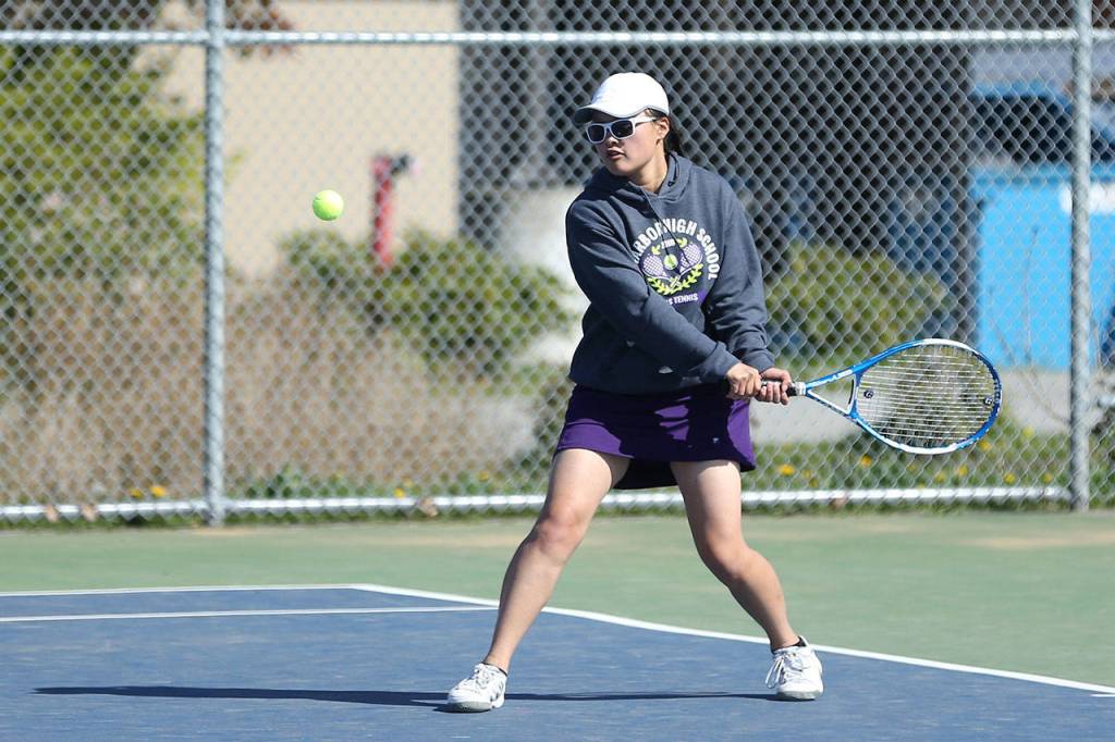 MJ Timm strokes a backhand while playing third singles Monday.(Photo by John Fisken)