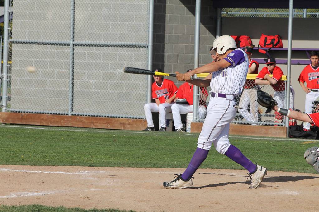 Aaron Martinez drives a base hit through the left-side hole in Wednesdays game.(Photo by Jim Waller/Whidbey News-Times)