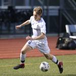 Nathan Merrill races to control the ball for Oak Harbor.(Photo by John Fisken)