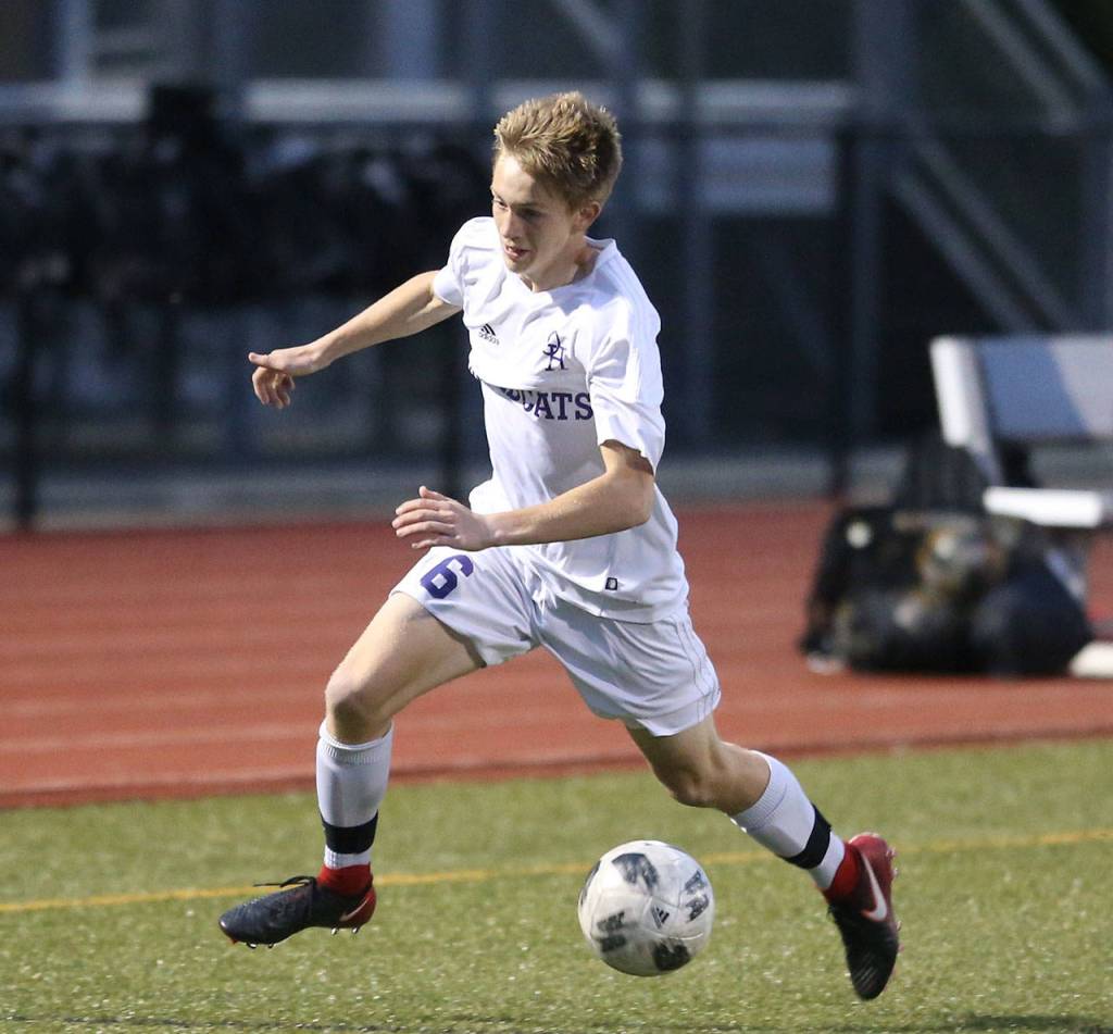 Nathan Merrill races to control the ball for Oak Harbor.(Photo by John Fisken)