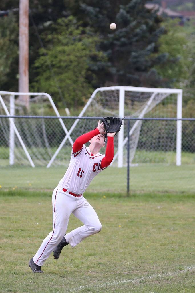 Rightfielder Kyle Rockwell runs down a Chimacum fly ball. (Photo by John Fisken)