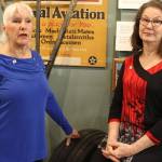 Writers Deborah Fisher (left) and Kellen Diamanti posed inside Oak Harbors PBY Naval Air Musuem before leaving for ceremonies launching their book, Stamp of the Century. Photo by Patricia Guthrie/Whidbey News Group