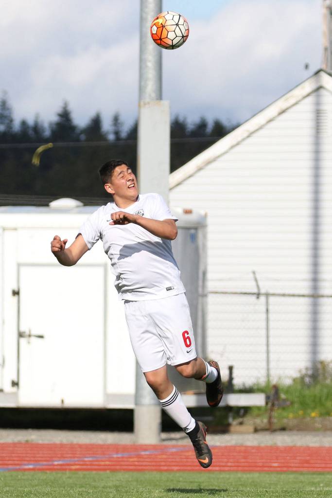 Alex Partida heads the ball ahead for the Wolves.(Photo by John Fisken)