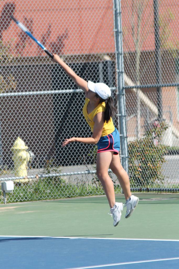 MJ Timm fires a serve against Arlington.(Photo by Jim Waller/Whidbey News-Times)