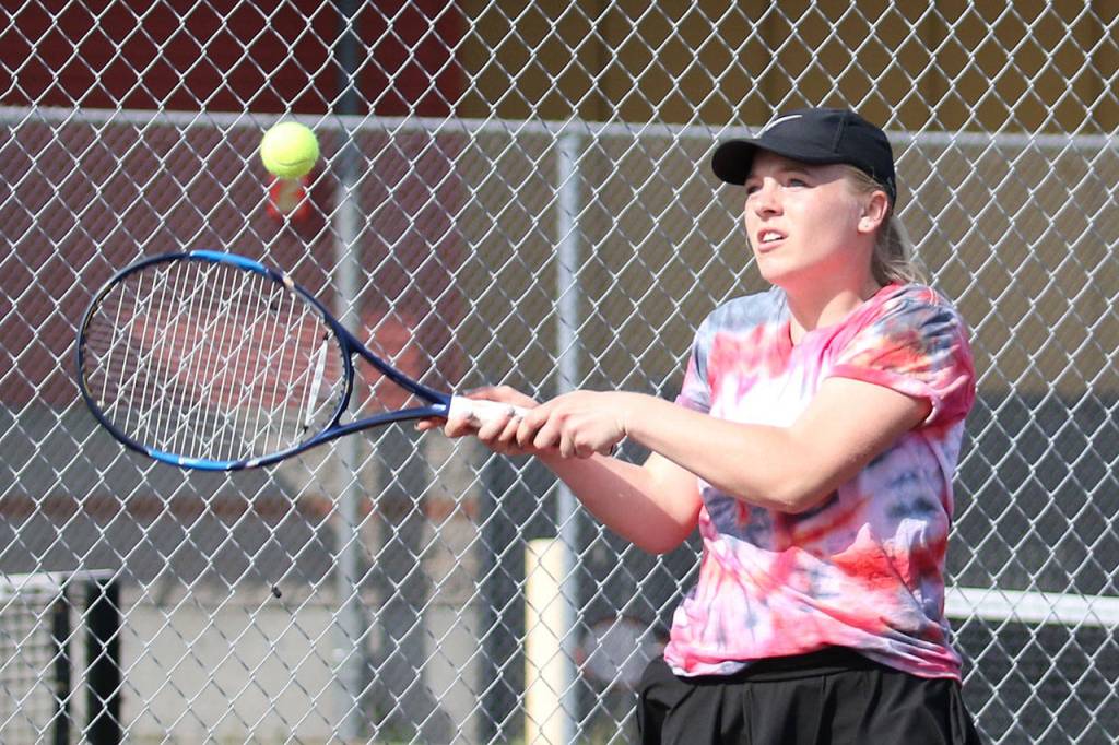 Sage Renninger goes on the attack in first doubles.(Photo by John Fisken)