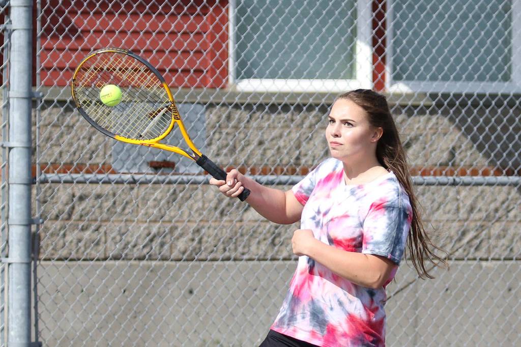 Senior Maggie Crimmins returns a shot in third doubles.(Photo by John Fisken)
