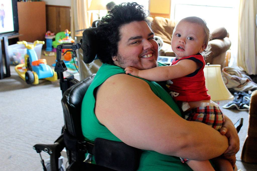 Scott Becktell hugs his nephew, Kenneth. Central Whidbey Hearts & Hammers widened doors and built a shower ramp.