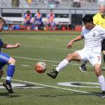 Coupevilles Aram Leyva kicks the ball by a Bellevue Christian defender in Saturdays district tournament match.(Photo by John Fisken)