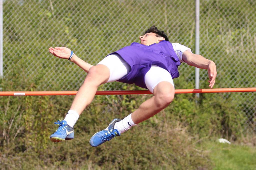 Matt Kelley flies over the bar in the high jump. (Photo by John Fisken)