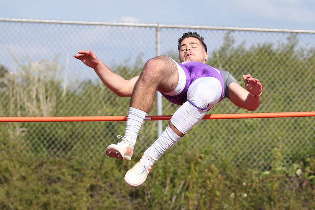 Kyle Nickols clears the bar in Fridays high jump competition.(Photo by John Fisken)
