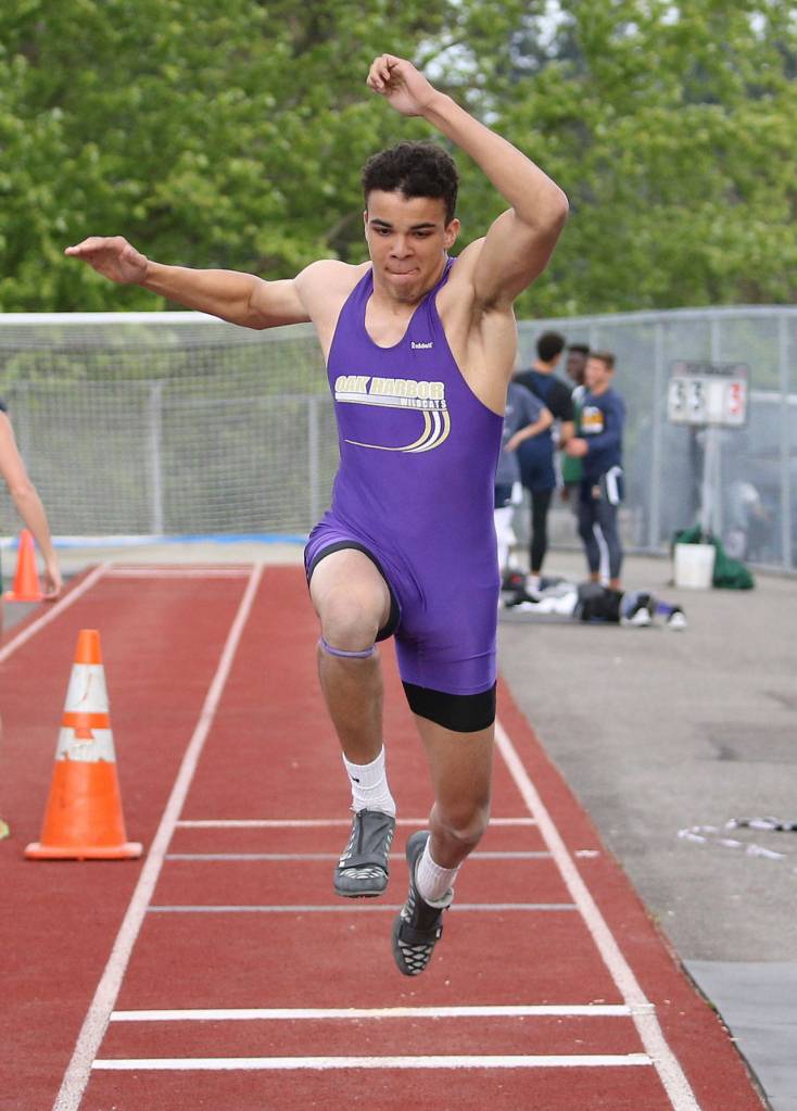 Ozell Jackson leaps to third place and a state berth in the triple jump. (Photo by John Fisken).