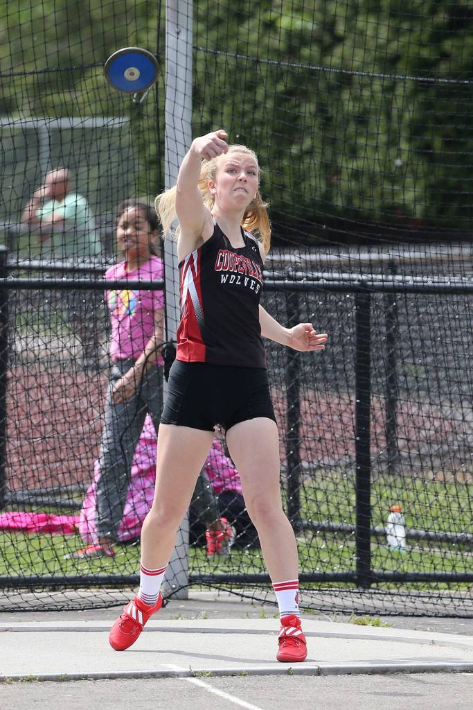 Allison Wenzel tosses the discus on the way to taking second place and earning a state berth.(Photo by John Fisken)