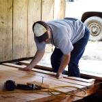 Scott Swenson, a National Park Service carpenter, puts the final pieces in on a ramp on the newly restored Pratt Sheep Barn. The 1930s barn will serve as a classroom one it officially opens in July. Photo by Laura Guido/Whidbey News Group