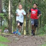 Crescent Harbor third-graders Sheldon Zabel, left, and Adam Garcia head down the path at Fort Nugent. (Photo by Jim Waller/Whidbey News-Times)