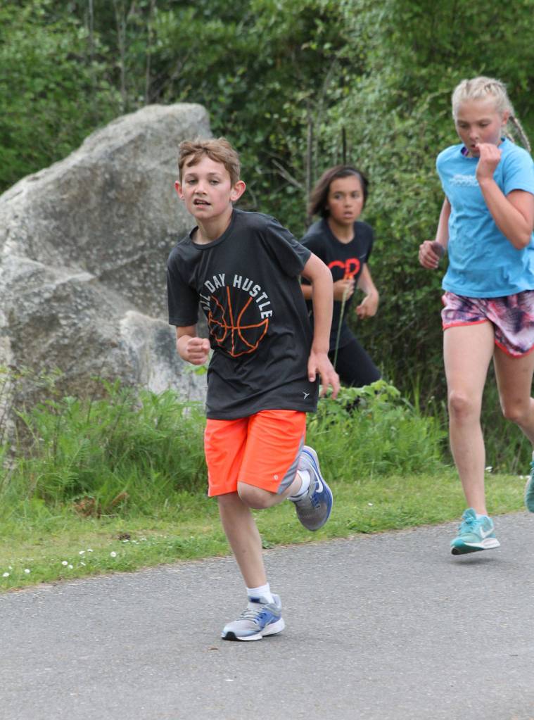 Oak Harbor Intermediates Landon Vandergrifft leads Addisen Boyer (blue shirt) and Jazmin Hernandez.(Photo by Jim Waller/Whidbey News-Times)