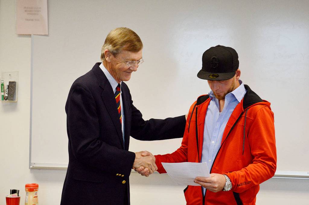 Island County Superior Court Judge Alan Hancock hands drug court graduate Conrad Standinger the dismissal of his charges, which Standinger earned after over 700 days in the rigerous court program. Photo by Laura Guido/Whidbey News Group