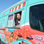 Glaiza Price, who owns and operates Cosmic Ice Cream with her husband Patrick, peeks out the vans window. The space-themed van has started popping up at events this year to serve 24 flavors of soft serve ice cream. Photo by Laura Guido/Whidbey News-Times