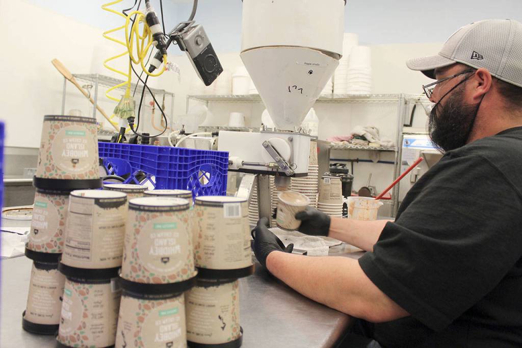 New pint containers are ready to be filled by Jason Moreno, who ensures every one is filled to the brim. Photo by Patricia Guthrie/Whidbey News Group