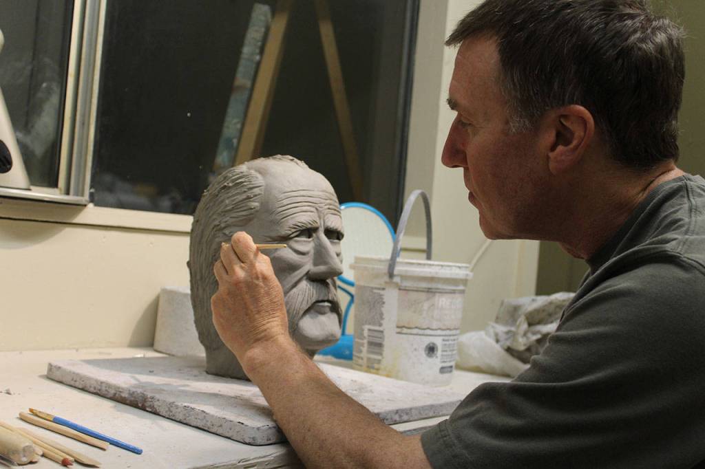 Jon Bloom works on one of his clay portraits at Freeland Art Studios.