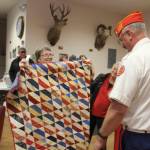 Photo by Patricia Guthrie / Whidbey News Group                                Frank Thorton receives a quilt from Anita Smith.