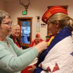 Anita Smith, founder of Quilts for Veterans, removes the name on the quilt after it was presented to M.J. Margaret Johns.