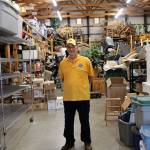 Photo by Maria Matson /Whidbey News Group.                                Coupeville Lions garage sale chairman Brian Pulk stands among piles of merchandise the club has collected in advance of their annual garage sale.
