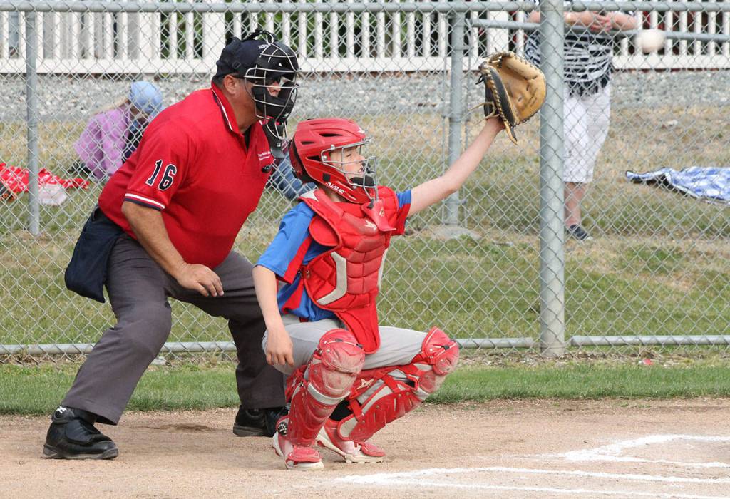 Catcher Jake Figarelle reaches to haul in a pitch.(Photo by Jim Waller/Whidbey News-Times)