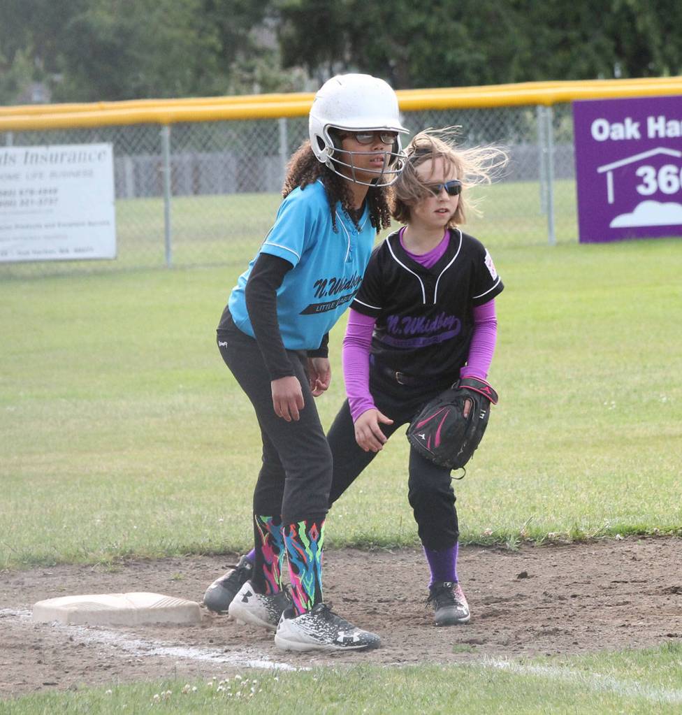 Bat Buster third baseman Emma Franklin holds on Jaylen Monreal.(Photo by Jim Waller/Whidbey News-Times)