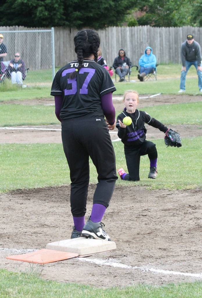Bat Buster second baseman Piper Lanning flips the ball to first baseman Loto Tupu for an out. (Photo by Jim Waller/Whidbey News-Times)