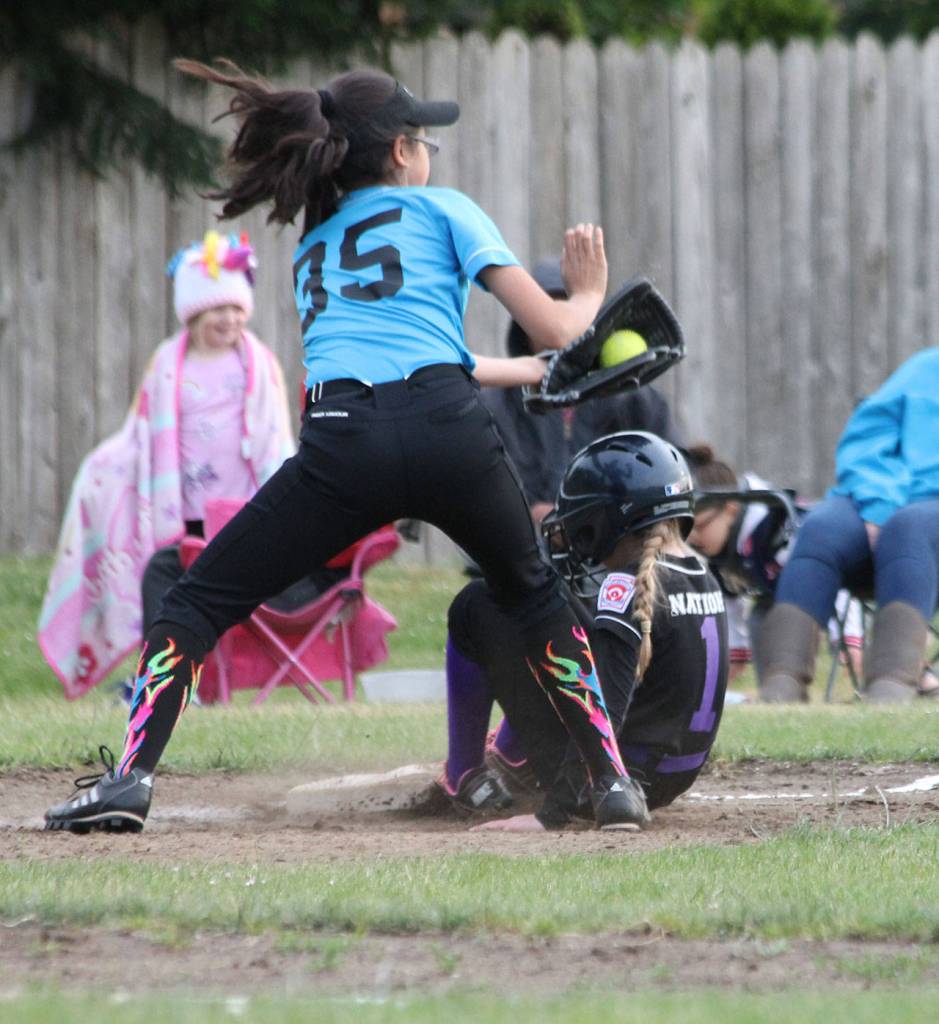 Scarlett Nations slides under the tag of Blue Dragon third baseman Jaylen Monreal.(Photo by Jim Waller/Whidbey News-Times)