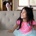 Harper Moon, 5, giggles after she told a joke to her mom at their home in Oak Harbor. The gregarious kindergartner has a budding acting and modeling career, including an appearance in an Amazon commercial and photo shoots with the e-commerce company Zulily. Photo by Laura Guido/Whidbey News-Times
