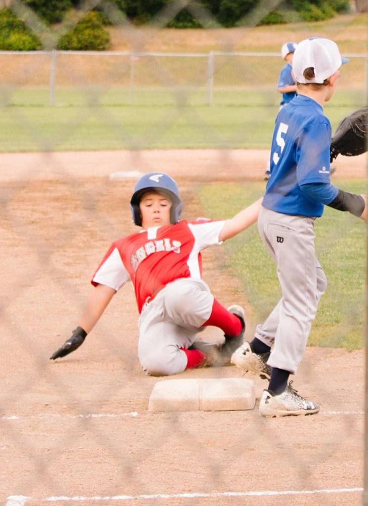 The Angels David Smith slides into third with a run-scoring triple.(Submitted photo)