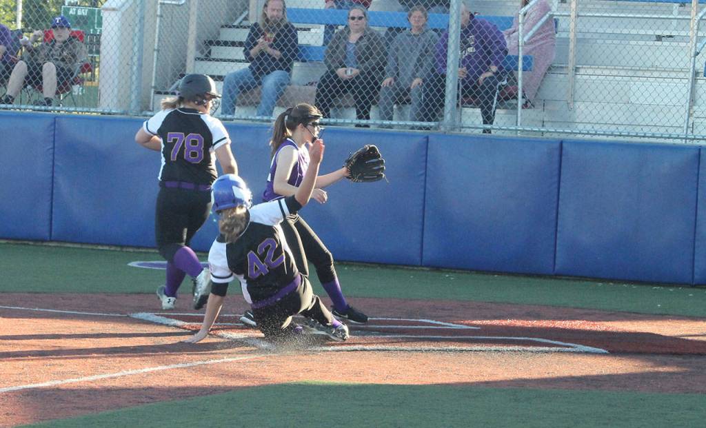 North Whidbeys Alyssia Grose scores on a wild pitch.(Photo by Jim Waller/Whidbey News-Times)