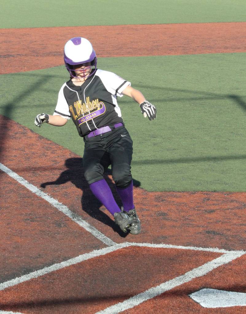 Jasmine Zenger slides home for another North Whidbey run.(Photo by Jim Waller/Whidbey News-Times)
