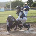 Olivia Aranguri-Plummer sneaks under the tag of Sedro-Woolley catcher Bryar Hart for a NW run. (Photo by Jim Waller/Whidbey News-Times)