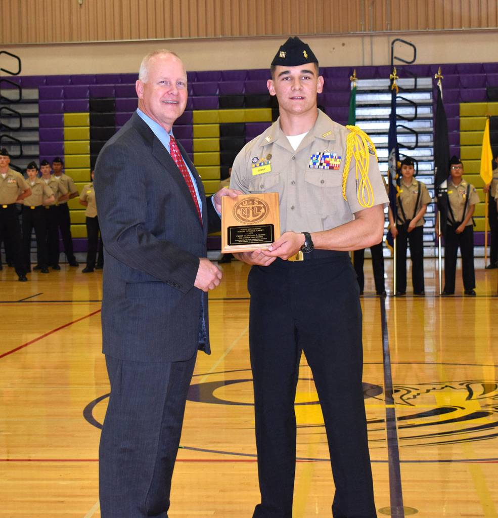 Senior Cadet Isaac Gomez receives the Navy League Outstanding Cadet award from Cmdr. Steve Bristow, USN (Ret.), president of the Oak Harbor Navy League.