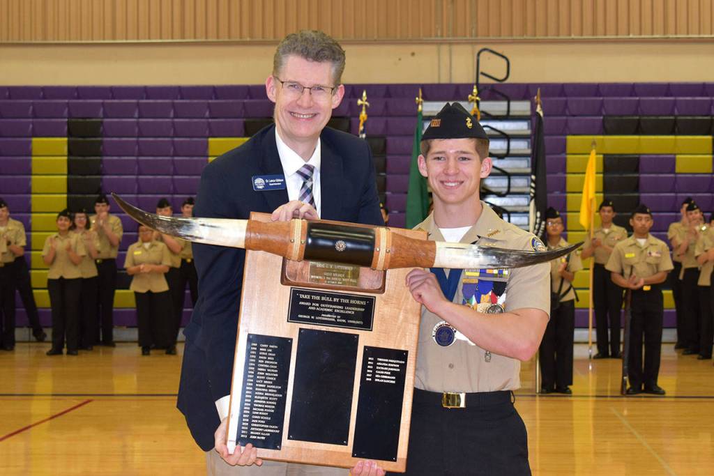 The RADM George Lotzenhiser Take the Bull by the Horns Leadership Award is presented by Dr. Lance Gibbon to Senior Cadet Dylan Sanchez.