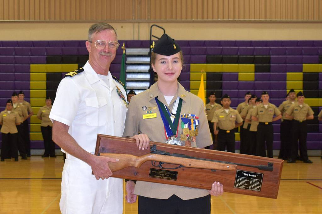 Cadet Lauren Crossley, shown with rifle team coach Lt. Cmdr. Dave Goodman, USN (Ret.), is the first sophomore to receive the Top Gun Marksmanship Award.