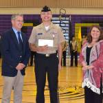 Scott Iversen and Marjie (Iversen) Jackson present Senior Cadet Ethan Wilson with the Iversen Scholarship.