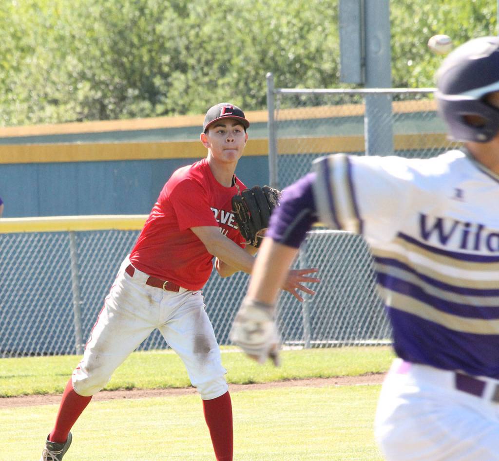 Coupevilles Hunter Smiths throw to first is in time to cut down an Oak Harbor hitter.(Photo by Jim Waller/Whidbey News-Times)