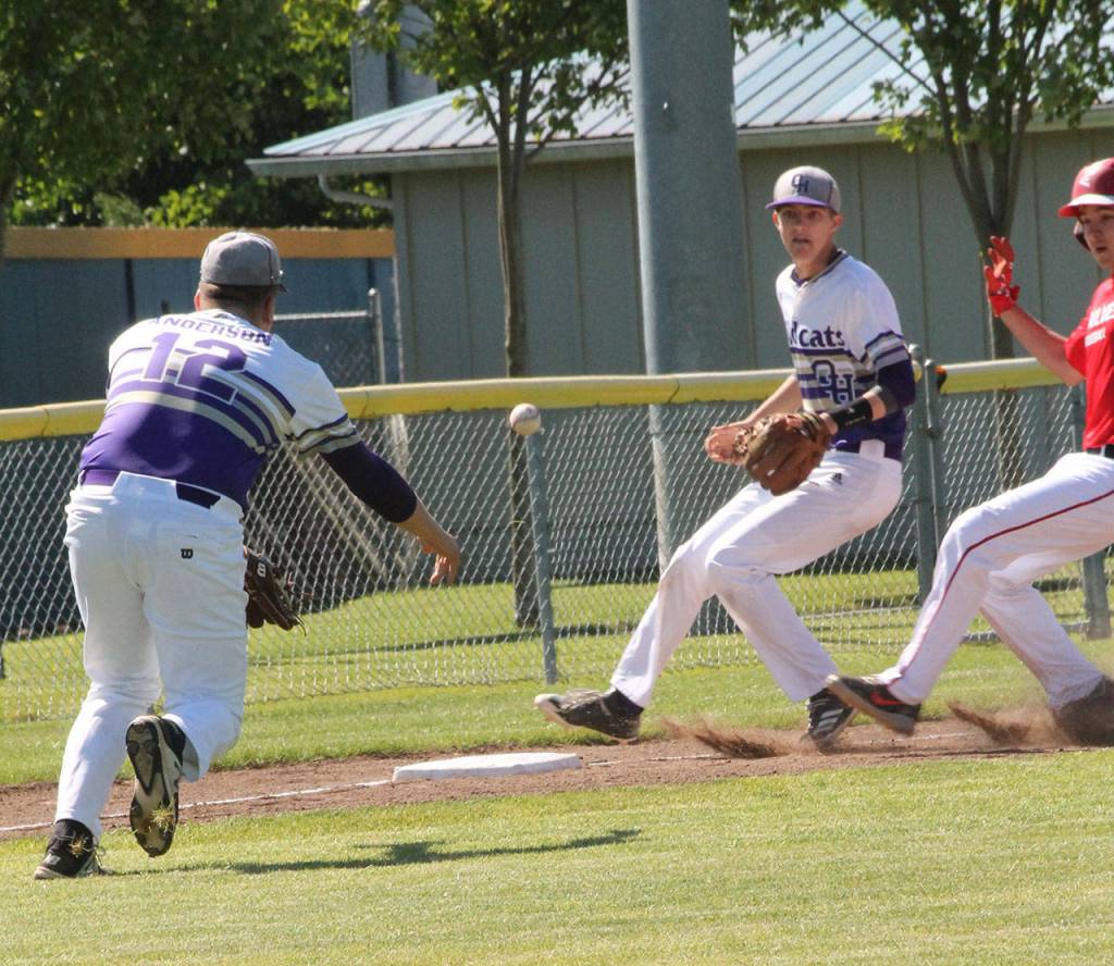 Oak Harbor third baseman Thomas Andersons toss to shortstop Joe Dixon is too late to get Jake Hoagland.(Photo by Jim Waller/Whidbey News-Times)